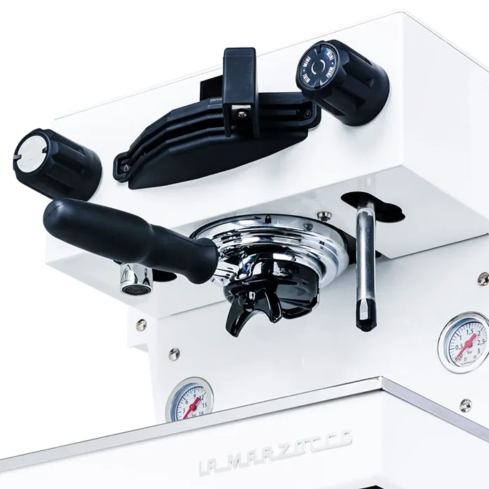 Close-up of the La Marzocco Linea Mini R White saturated group head, emphasizing its robust, commercial-grade design