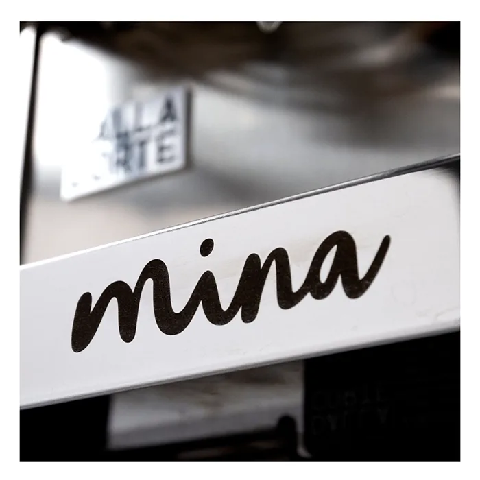 A smartphone screen showing the Dalla Corte Mina Espresso Machine Glass App, with options for creating and saving flow profiles