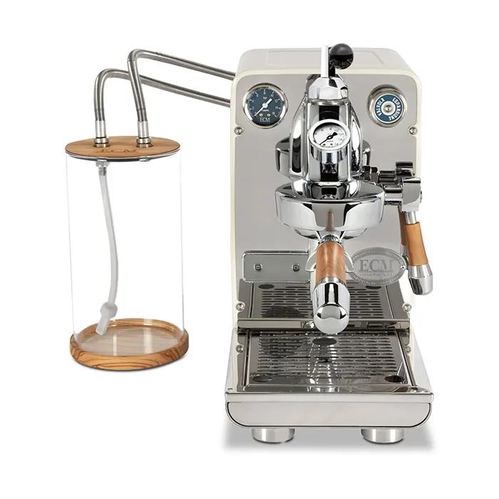 A stylish cream-colored ECM Puristika Espresso Machine, showcasing its compact size and unique glass water tank