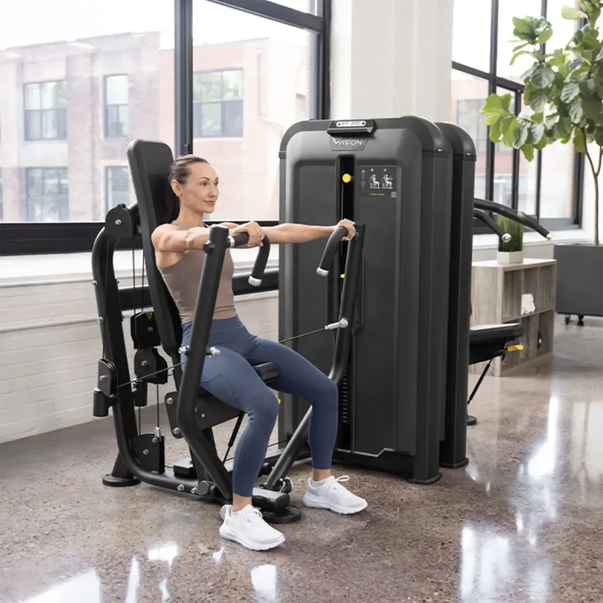 Vision chest press with independent arms and gas-assisted seat adjustment