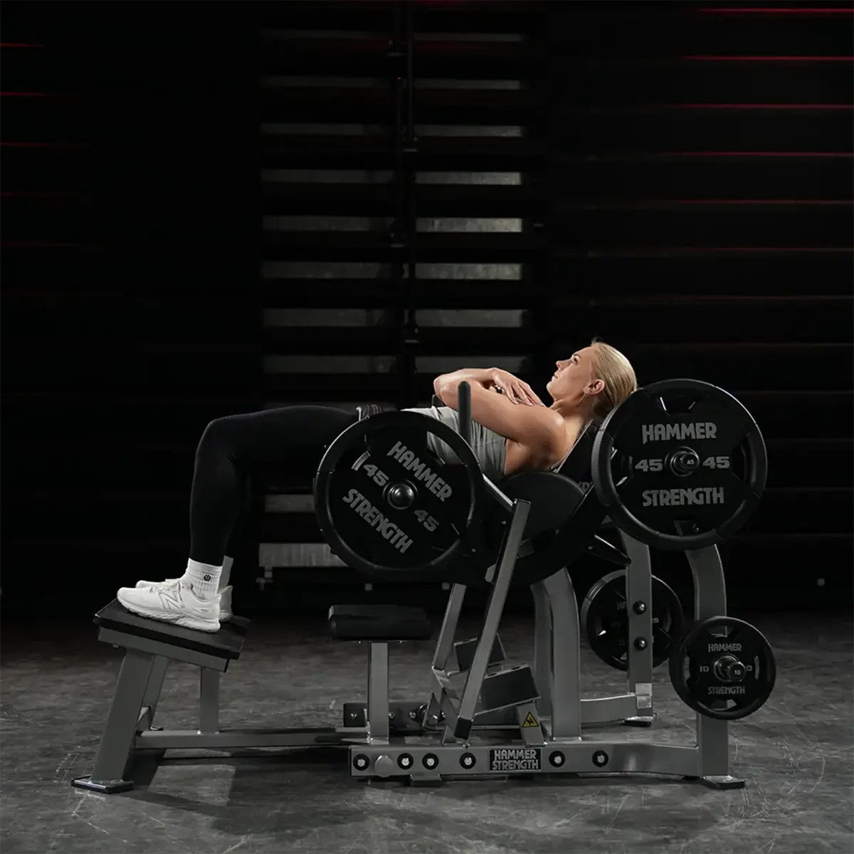 Hammer Strength Plate-loaded glute machine with angled foot platform and band pegs