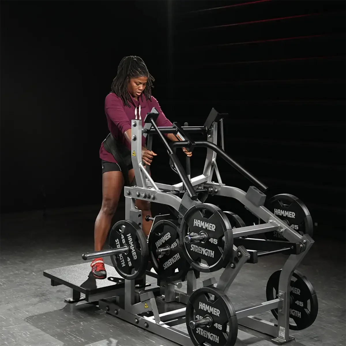 Hammer Strength belt squat with front and rear weight rods