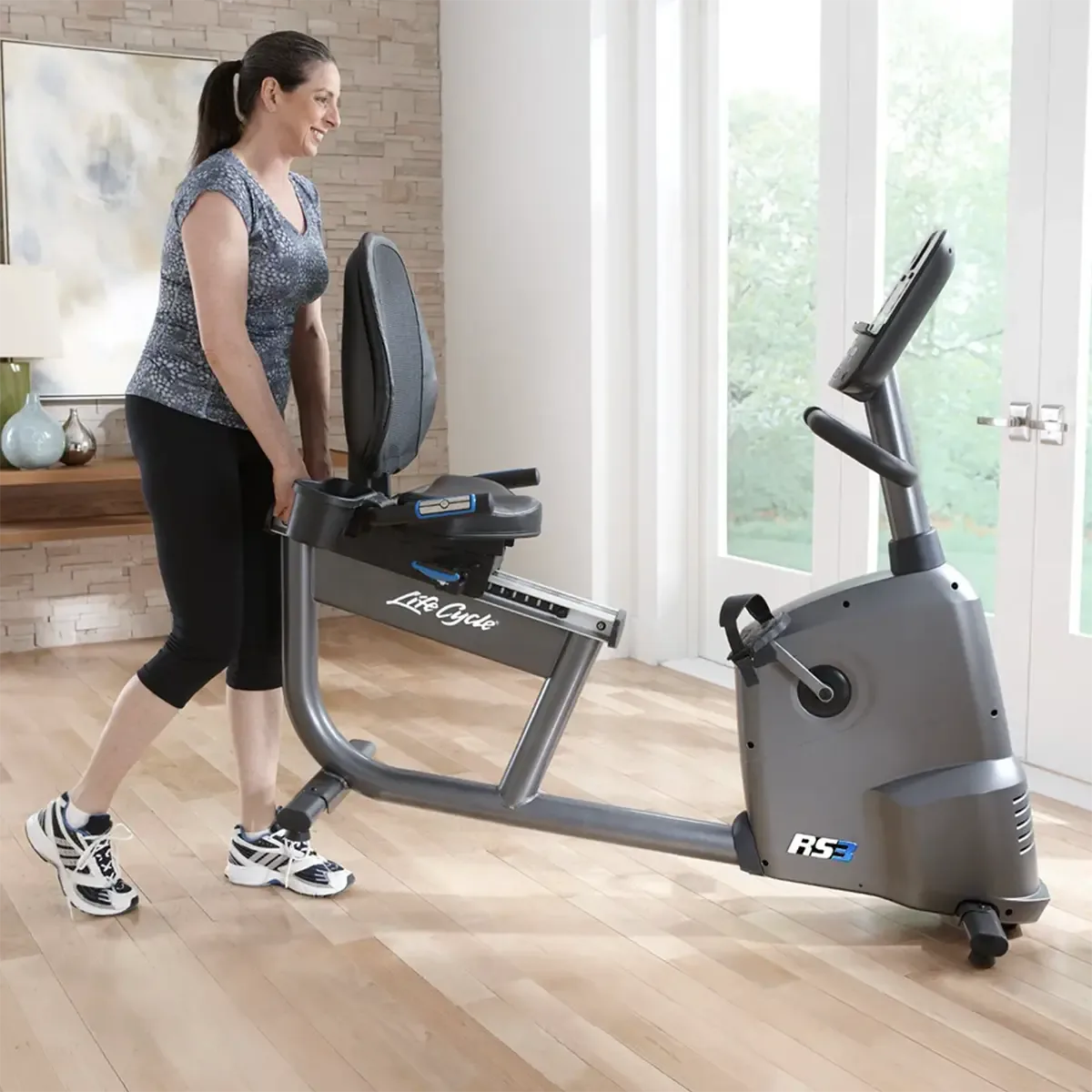Recumbent exercise bike with mesh back seat and side-mounted handlebars