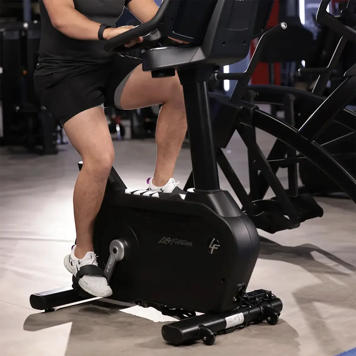Club Series+ upright bike with removable cup holders and wide ride pedals
