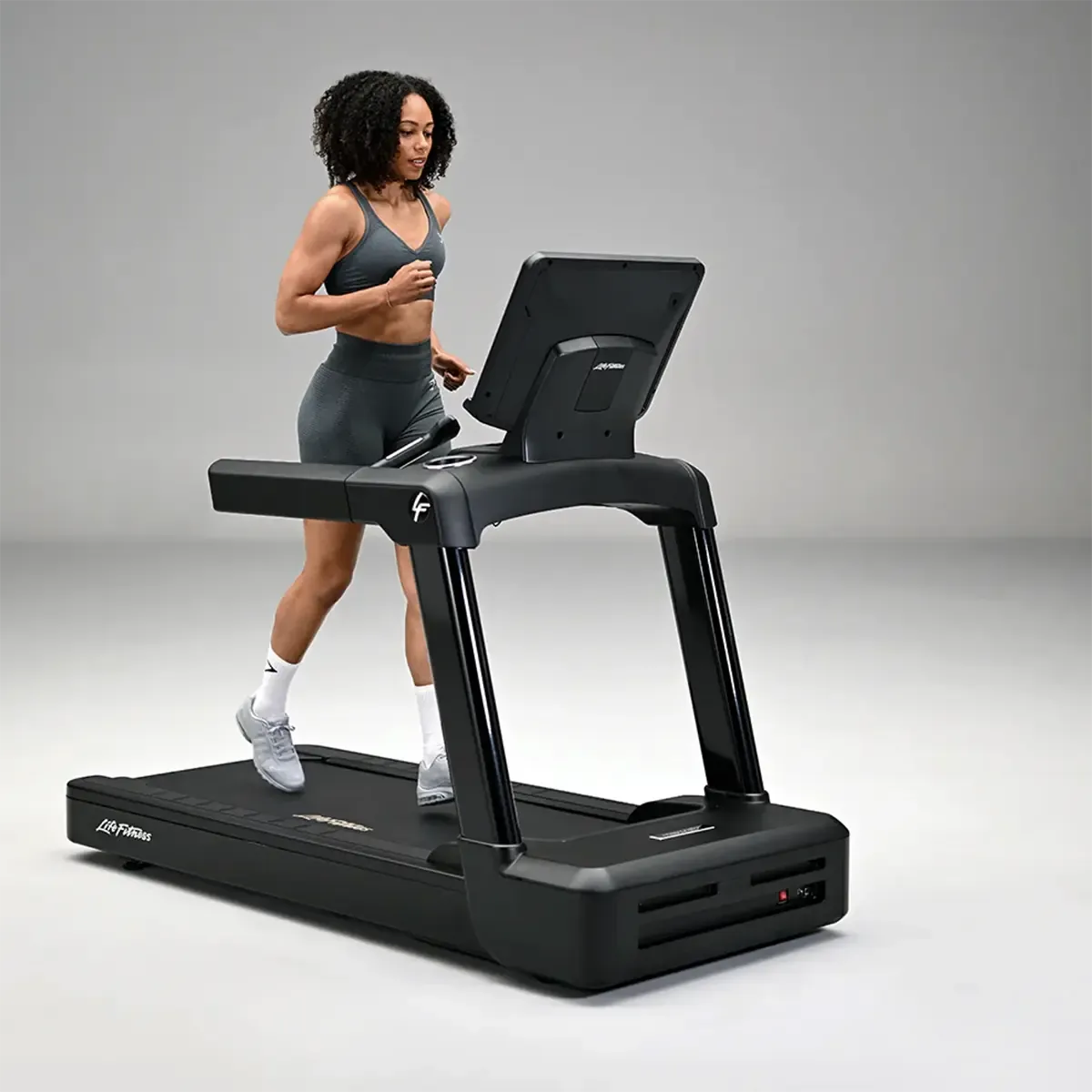 Life Fitness treadmill with Ergobar, cup holders, and front wheels