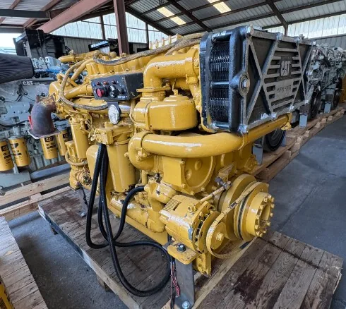 Industrial diesel engine generator; yellow unit with front radiator, visible hoses and drive belts